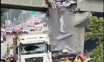 devastating crash: a large truck tears through an overpass, halting traffic completely