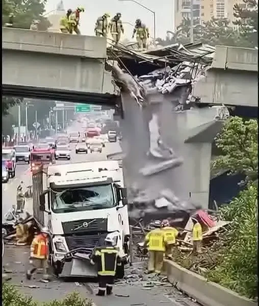 devastating crash: a large truck tears through an overpass, halting traffic completely