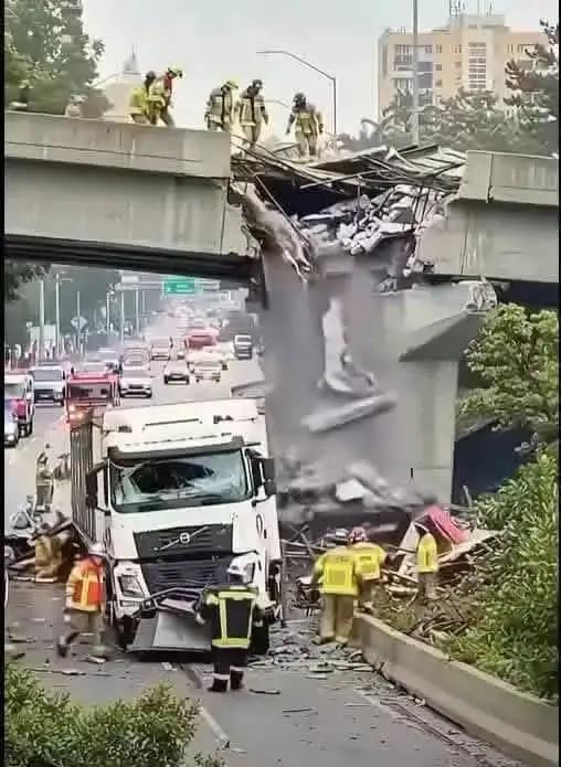 devastating crash: a large truck tears through an overpass, halting traffic completely
